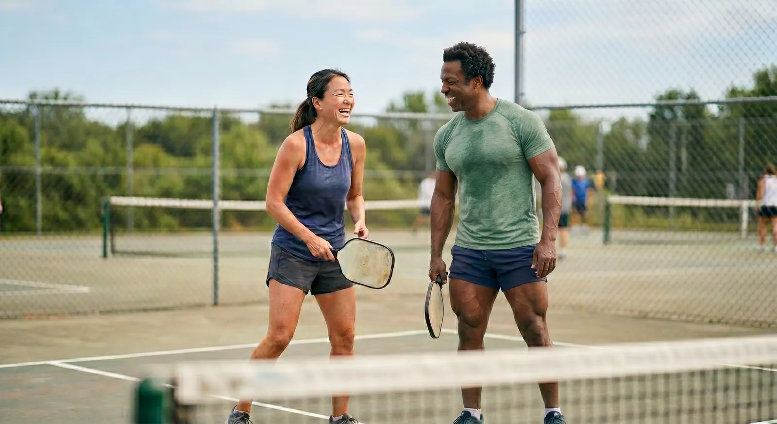 An active couple playing pickleball
